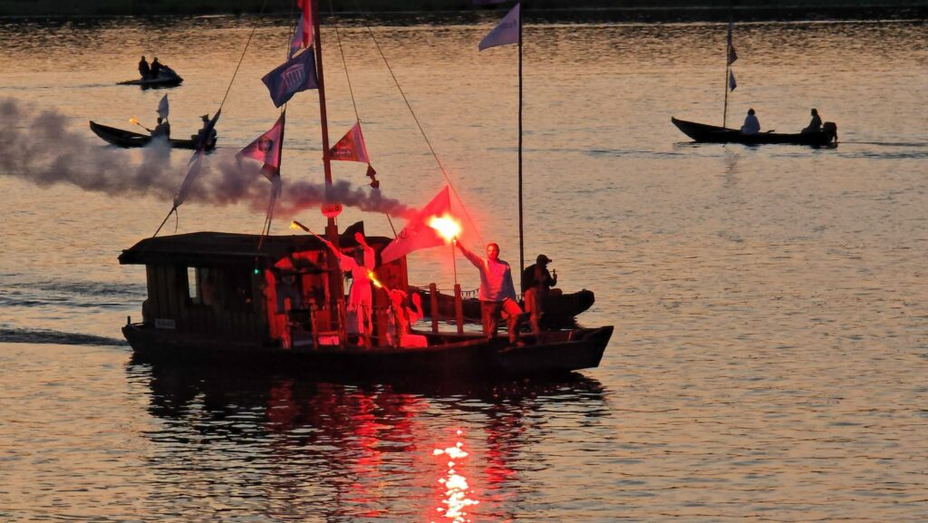Wieczorna parada łodzi z racami na Wiśle podczas Festiwalu Wisły
